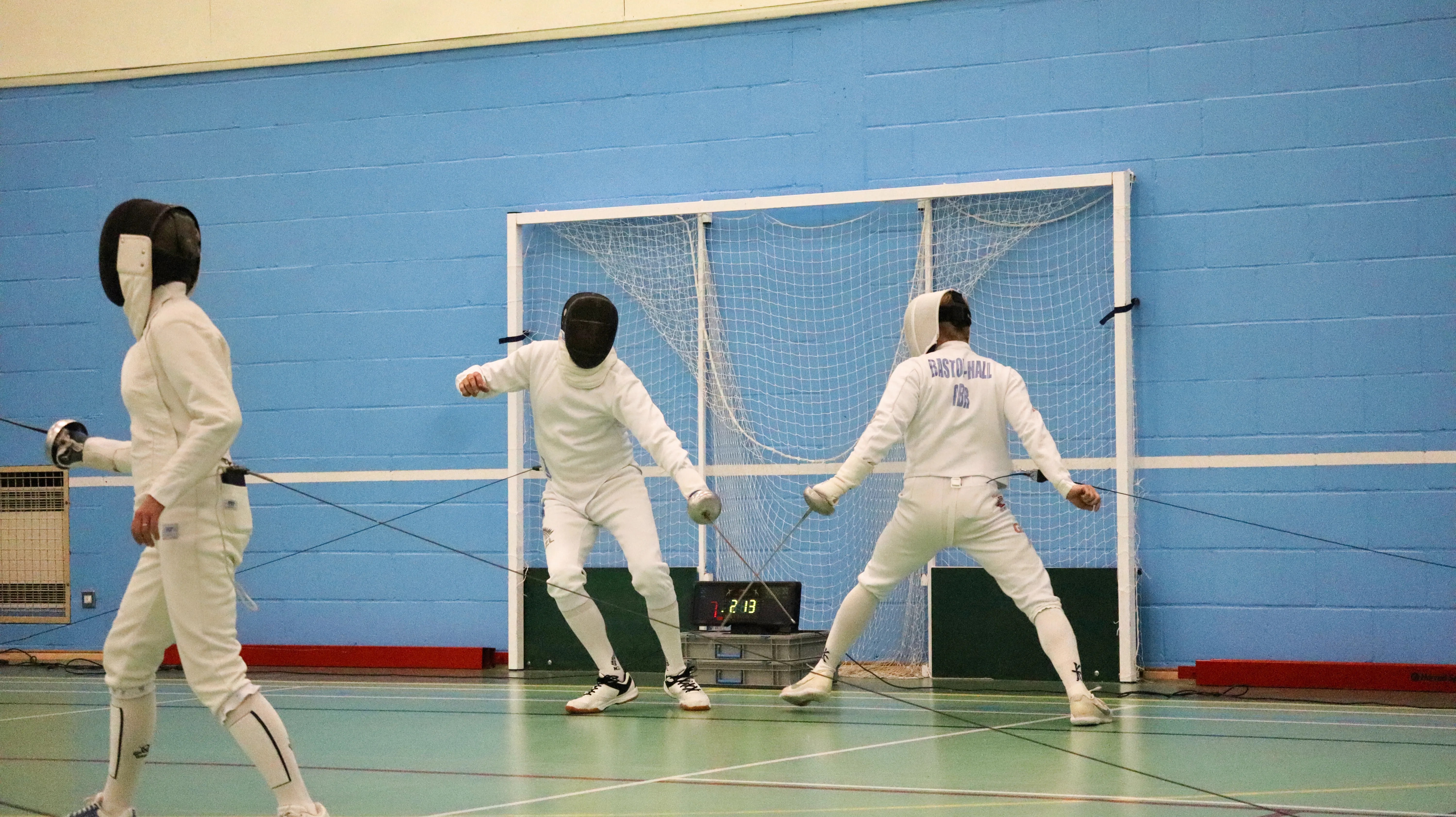 Two épée fencers squaring off at close distance.